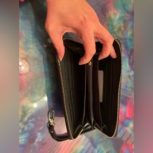 Clutch cross stitch wallet with matching wristlet strap.